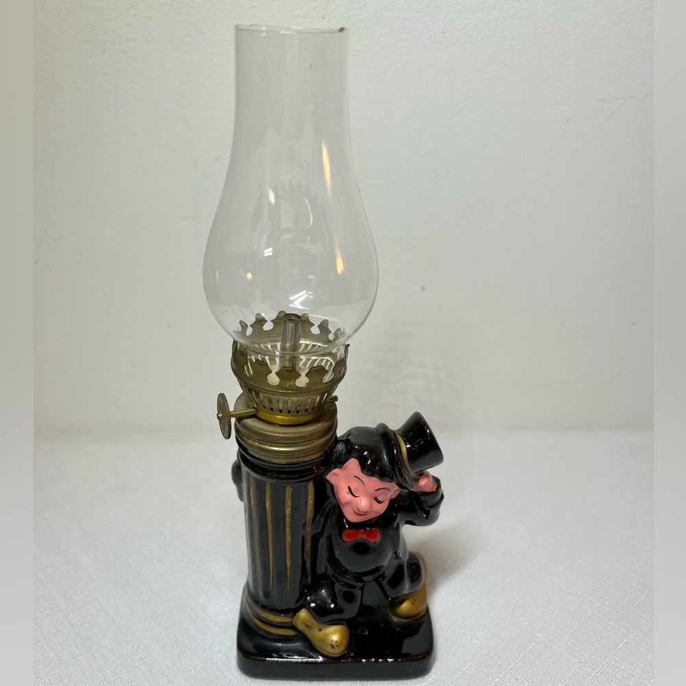 Mini vintage ceramic oil lamp "drunk man" character leaning on a lamp post.